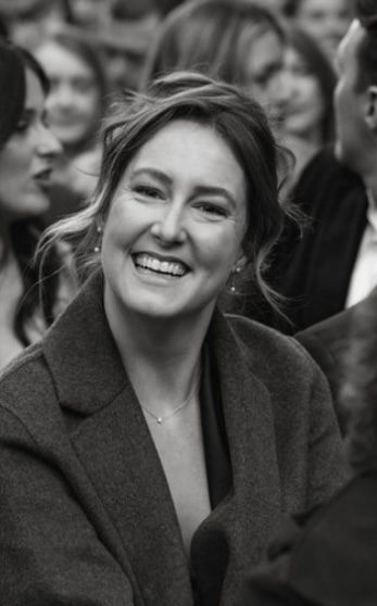 Liz laughing in a crowd