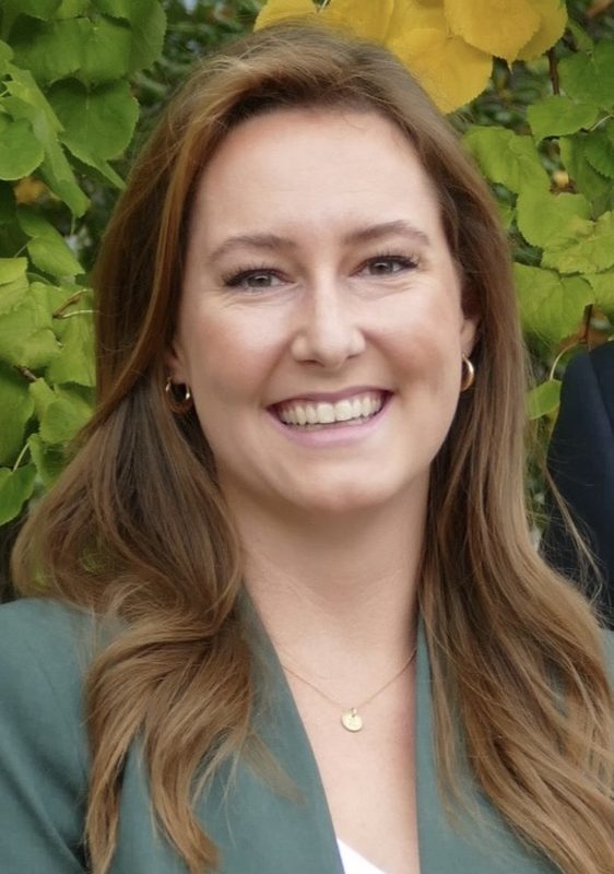 Liz outdoors in green blazer
